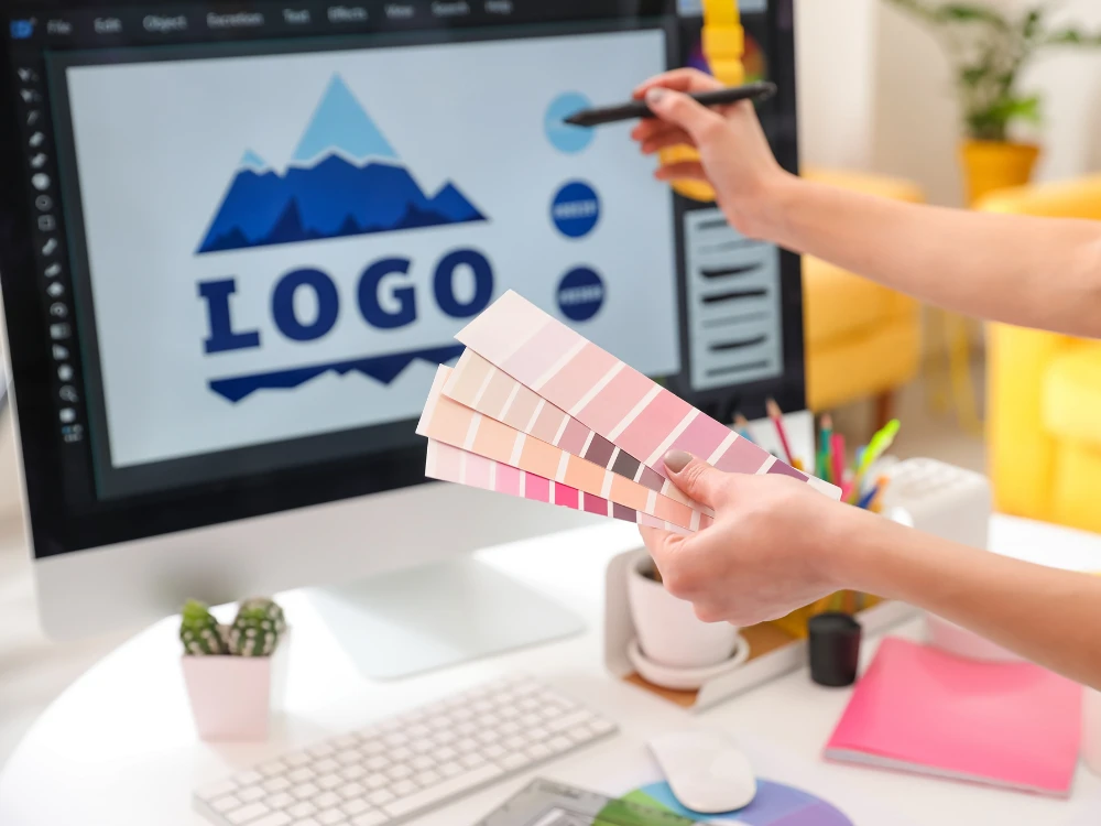Logo designer sketching black and white concept shapes before color